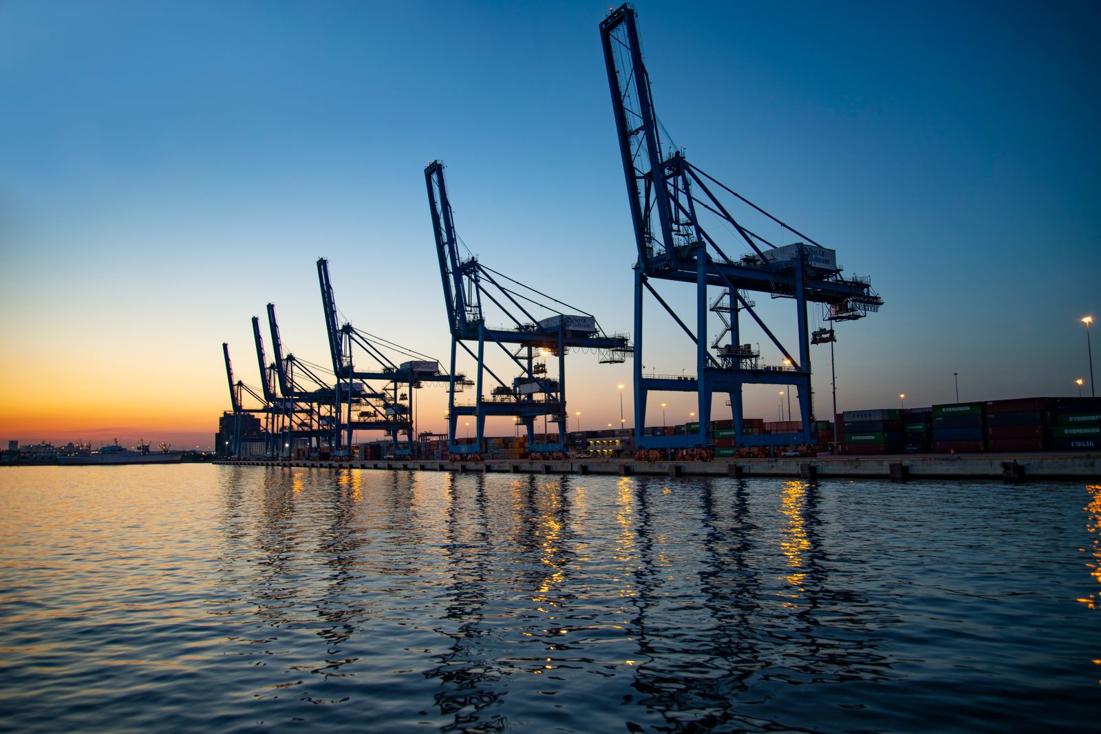 Port cranes silhouette at sunset