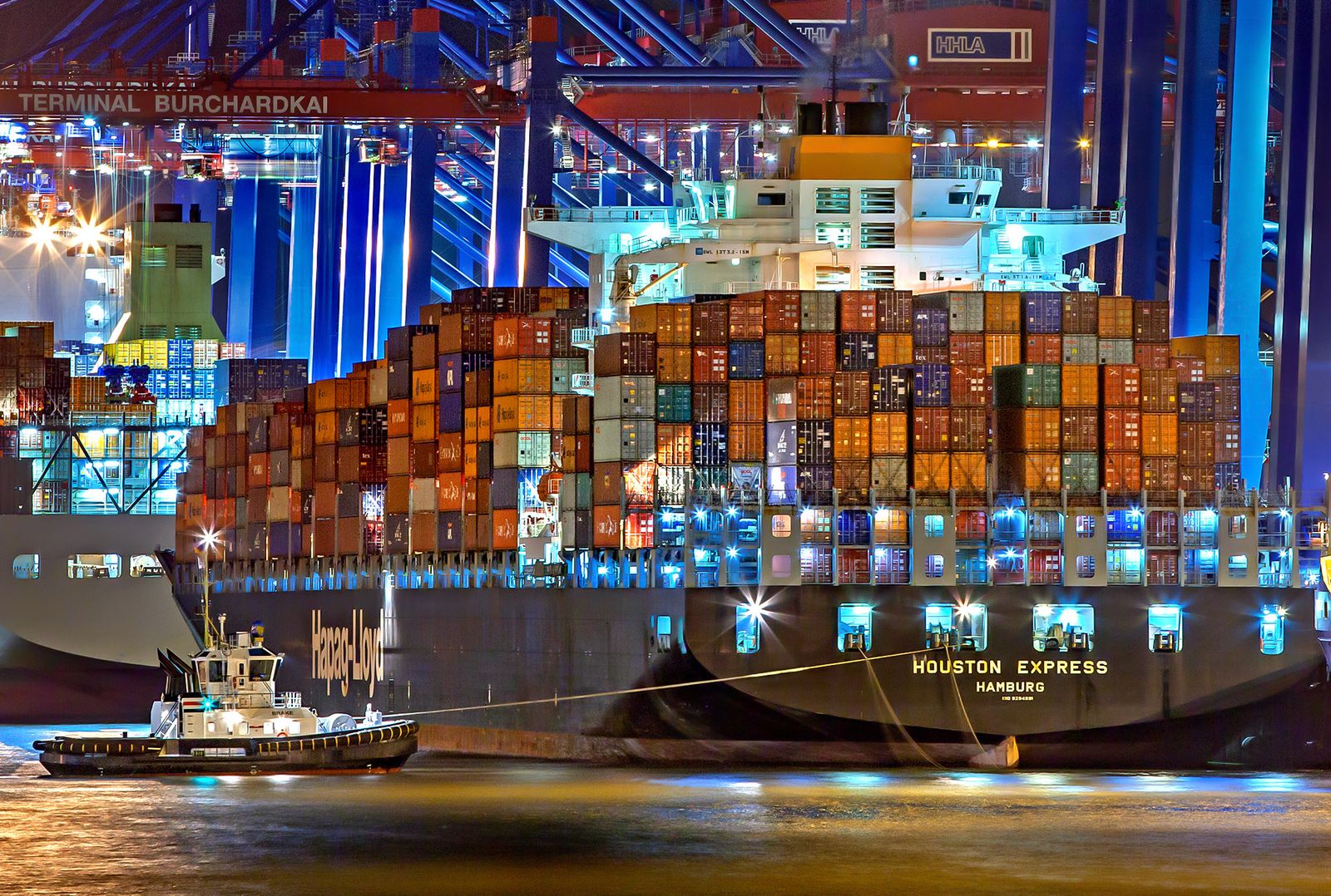 Container ship at illuminated night terminal